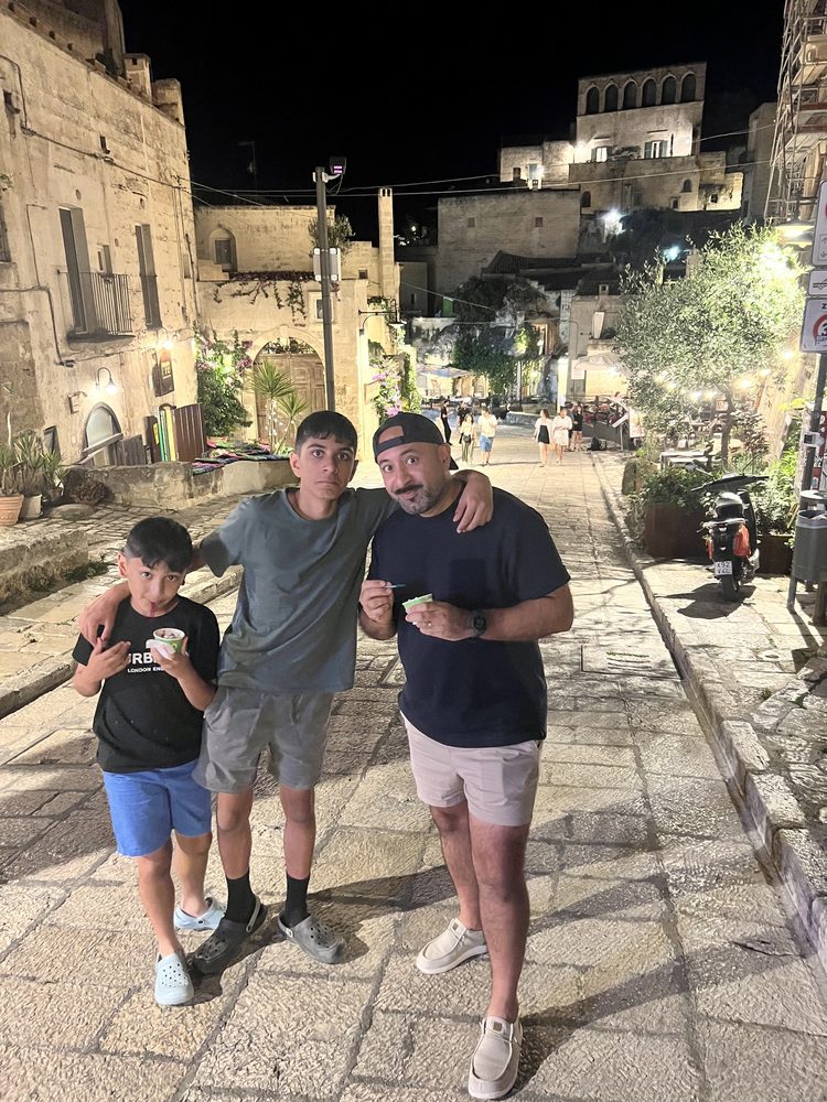Sonny and his two sons eating gelato in the streets of Matera at night